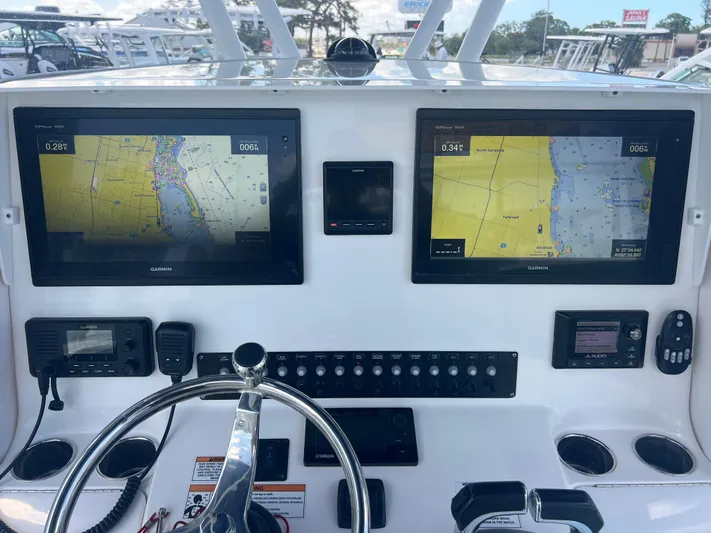  Yacht Photos Pics Dashboard of a 2019 Contender 32 ST boat with navigation screens and controls.