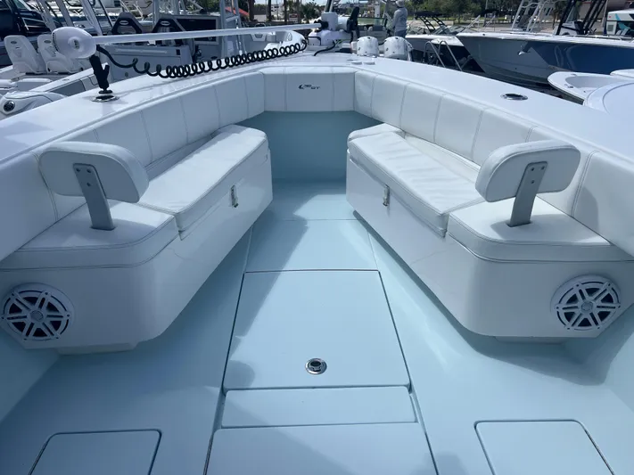  Yacht Photos Pics 2019 Contender 32 ST boat interior with white cushioned seating and storage compartments.