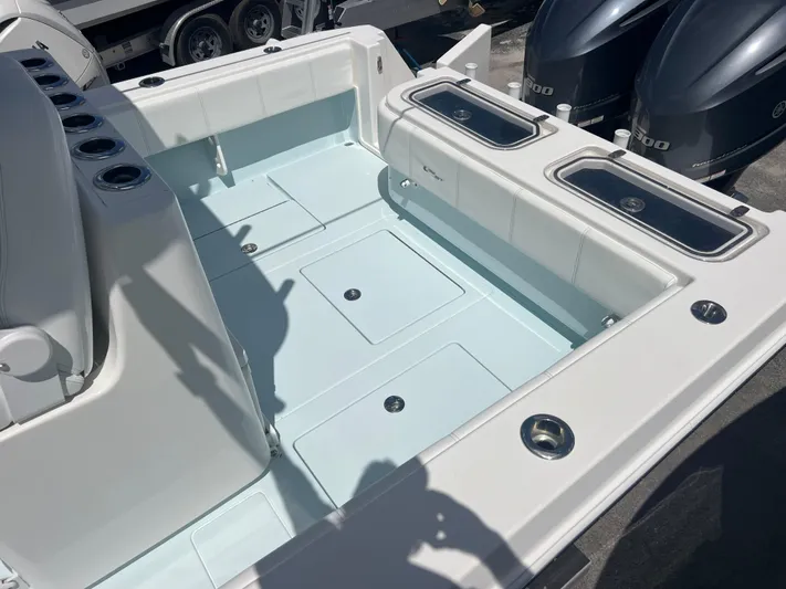  Yacht Photos Pics 2019 Contender 32 ST boat deck with storage compartments and dual outboard motors.