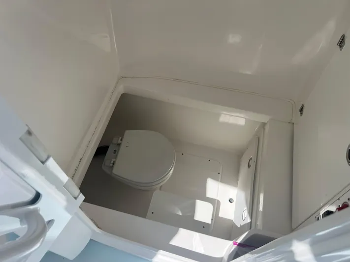  Yacht Photos Pics 2019 Contender 32 ST boat interior with compact marine toilet.