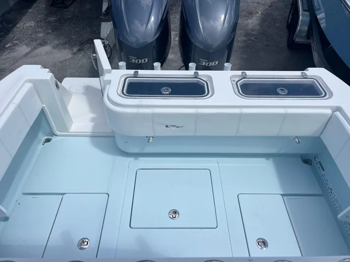  Yacht Photos Pics 2019 Contender 32 ST boat deck with dual outboard engines and storage compartments.