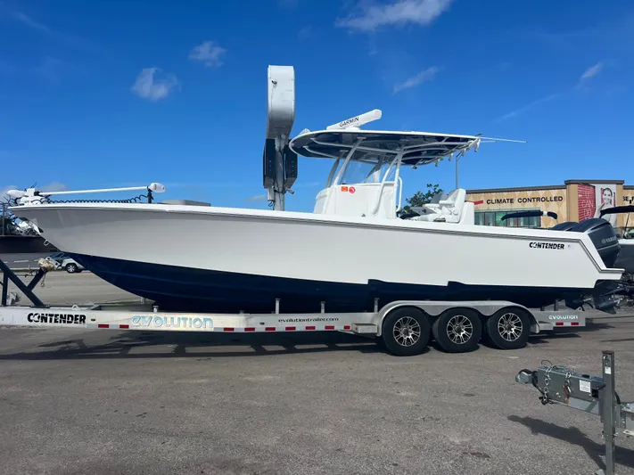  Yacht Photos Pics 2019 Contender 32 ST boat on trailer, parked outdoors under clear blue sky.