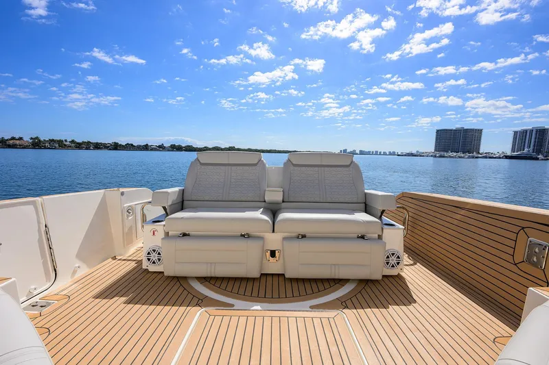  Yacht Photos Pics 2022 Tiara Yachts 43 LE with luxurious seating on a sunny deck, overlooking calm waters.