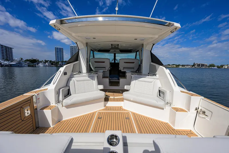  Yacht Photos Pics 2022 Tiara Yachts 43 LE luxury boat interior with seating, docked in a scenic marina.
