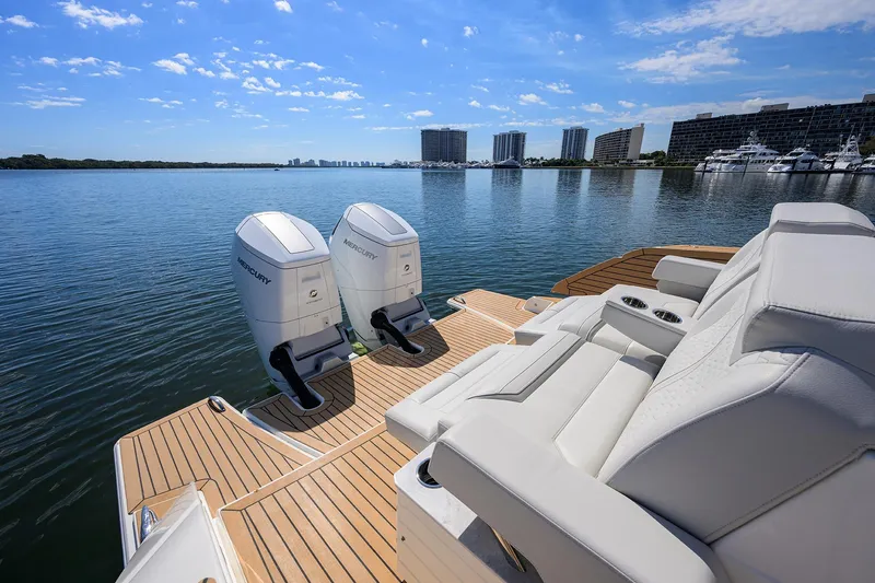  Yacht Photos Pics 2022 Tiara Yachts 43 LE with dual Mercury engines on a serene waterfront.