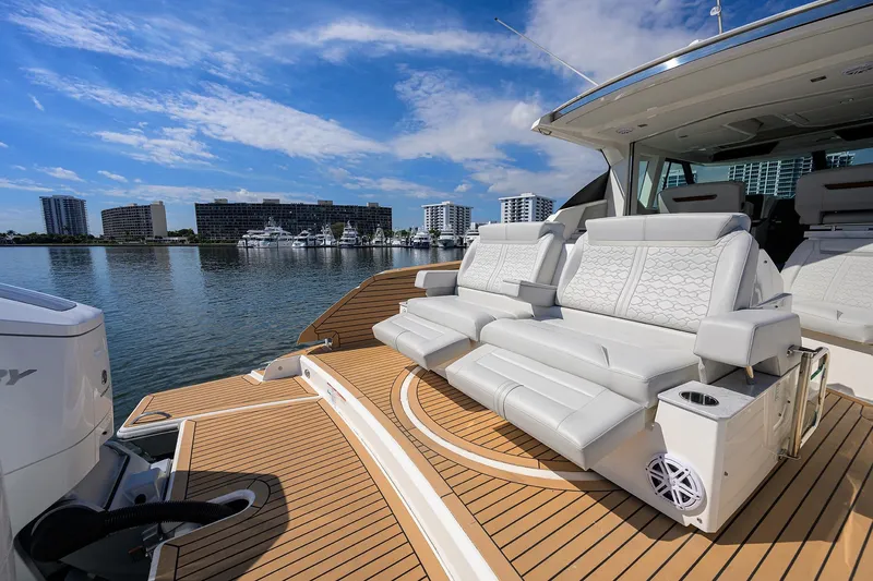  Yacht Photos Pics Luxurious 2022 Tiara Yachts 43 LE with elegant seating, docked in a scenic marina.