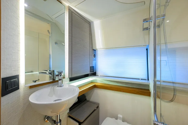  Yacht Photos Pics Luxurious bathroom interior of 2022 Tiara Yachts 43 LE with modern fixtures and lighting.