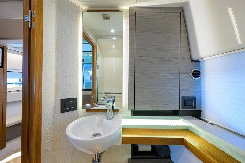  Yacht Photos Pics Luxurious bathroom interior of 2022 Tiara Yachts 43 LE with modern sink and lighting.