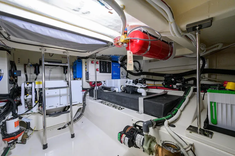  Yacht Photos Pics Engine room of 2022 Tiara Yachts 43 LE, featuring equipment and fire extinguisher.