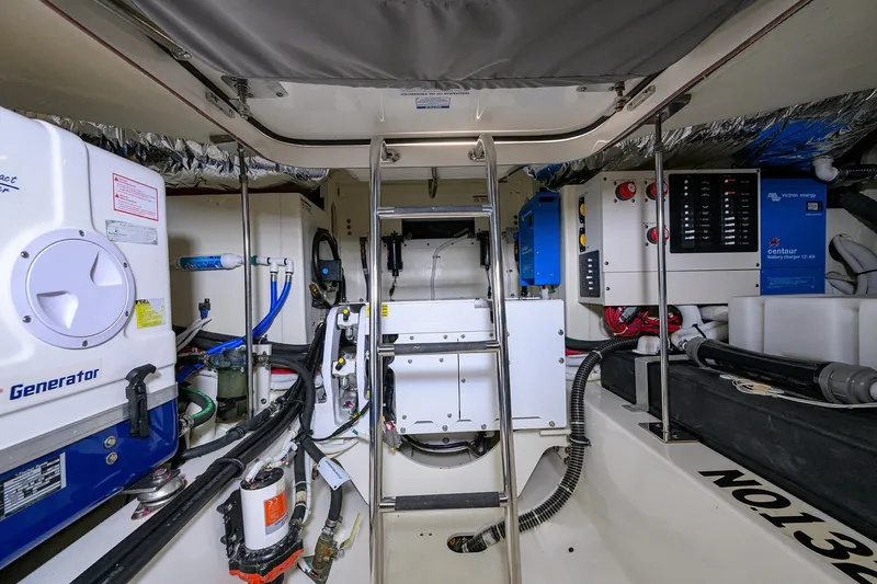  Yacht Photos Pics Engine room of 2022 Tiara Yachts 43 LE, featuring generator and battery charger systems.
