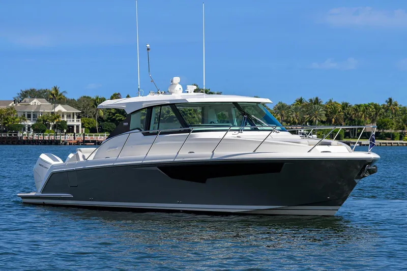  Yacht Photos Pics 2022 Tiara Yachts 43 LE luxury boat on calm water, scenic background.