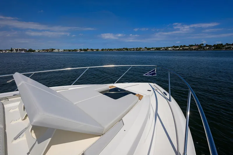  Yacht Photos Pics 2022 Tiara Yachts 43 LE on calm water, featuring a sunbed on the bow.