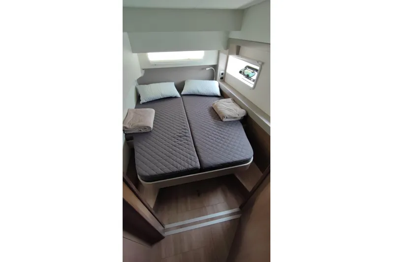  Yacht Photos Pics Cozy cabin bedroom in 2023 Bali 4.2 yacht with double bed and window view.