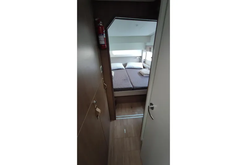  Yacht Photos Pics Interior of 2023 Bali 4.2 yacht cabin with bed and fire extinguisher.