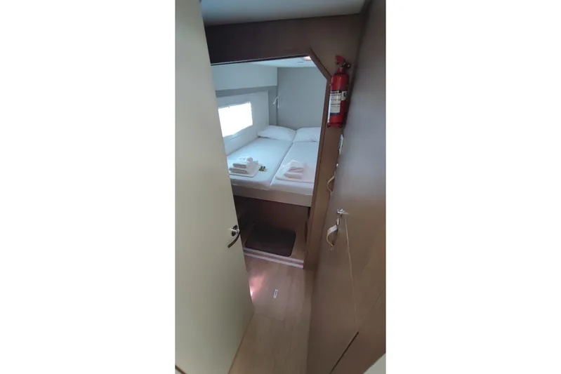  Yacht Photos Pics Cozy cabin interior of 2023 Bali 4.2 yacht with bed and fire extinguisher.