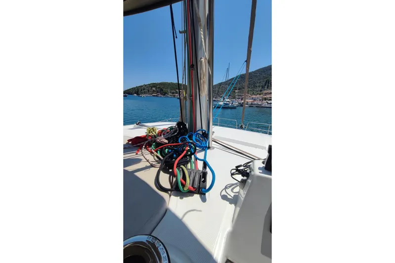  Yacht Photos Pics Sailing yacht Bali 4.2, 2023 model, with colorful ropes on deck, docked in a scenic harbor.