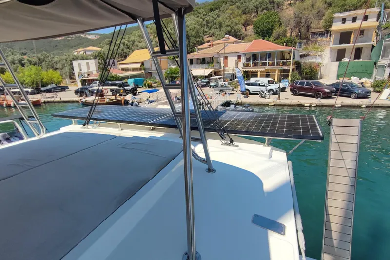  Yacht Photos Pics 2023 Bali 4.2 yacht with solar panels docked at a scenic marina.