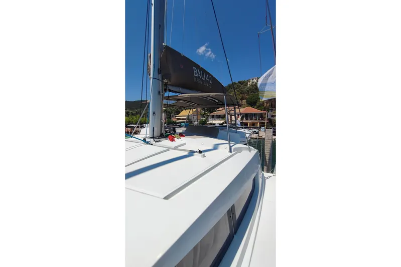  Yacht Photos Pics 2023 Bali 4.2 catamaran docked at marina under clear blue sky.