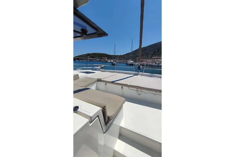  Yacht Photos Pics 2023 Bali 4.2 yacht deck with scenic harbor view and clear blue sky.