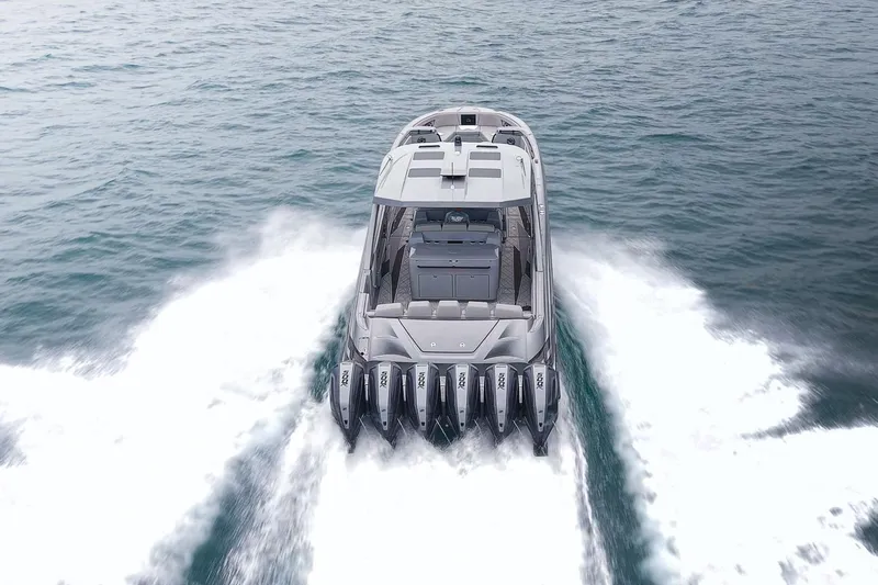  Yacht Photos Pics 2026 Deep Impact 499 Sport boat cruising on open water, rear view.