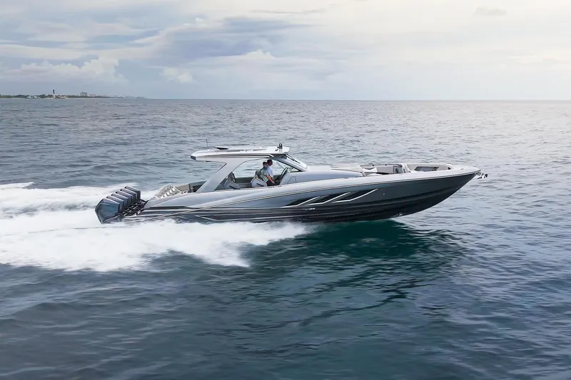  Yacht Photos Pics 2026 Deep Impact 499 Sport boat cruising on open water, showcasing sleek design and speed.