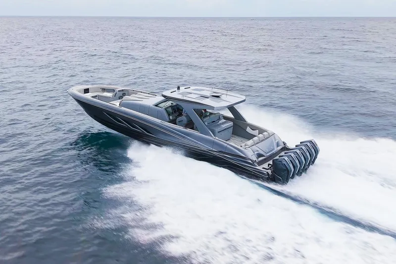  Yacht Photos Pics 2026 Deep Impact 499 Sport boat cruising swiftly on open water.