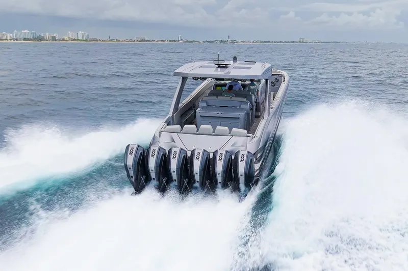  Yacht Photos Pics 2026 Deep Impact 499 Sport boat cruising on open water with powerful engines.