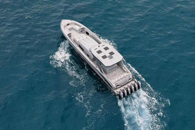  Yacht Photos Pics Aerial view of 2026 Deep Impact 499 Sport boat cruising on blue ocean waters.