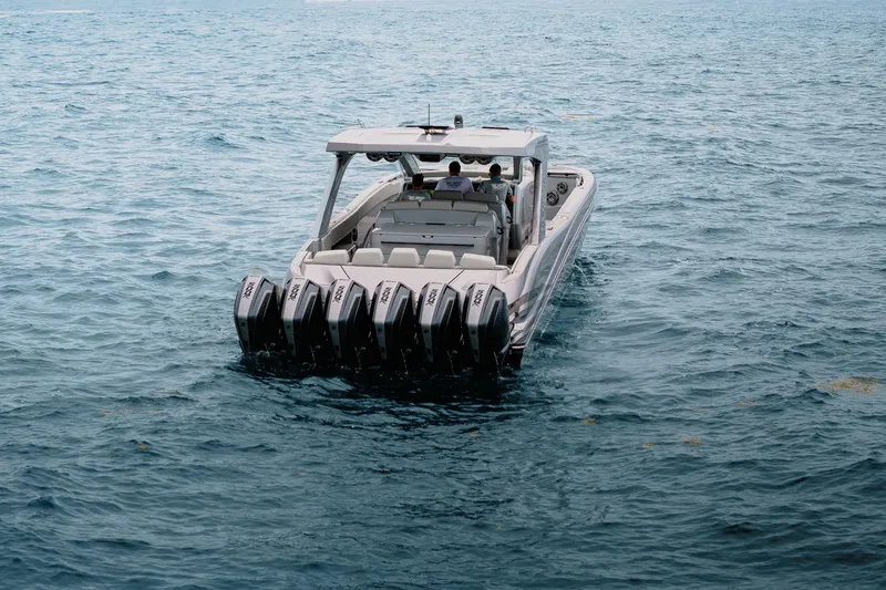  Yacht Photos Pics 2026 Deep Impact 499 Sport boat with multiple engines on open water.