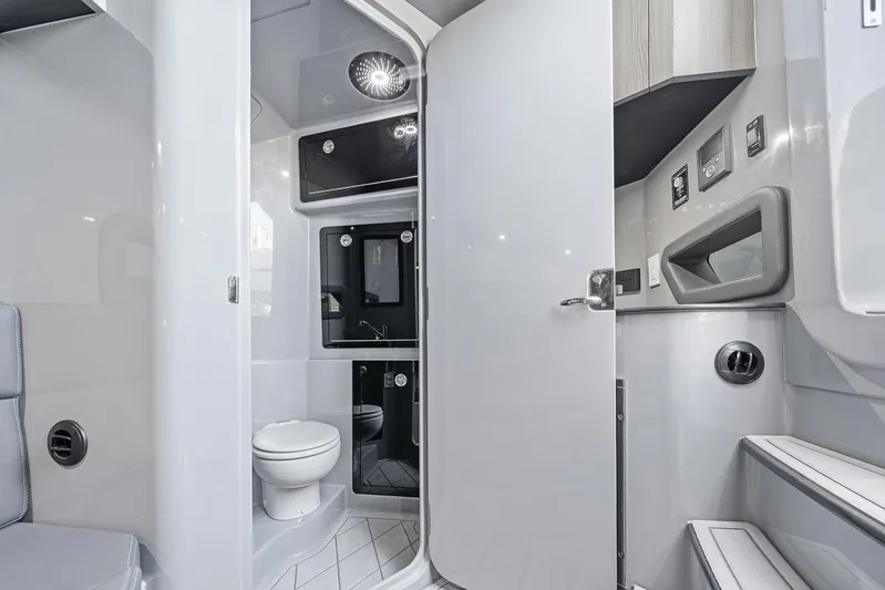  Yacht Photos Pics Modern bathroom interior in 2026 Deep Impact 499 Sport boat, featuring sleek design and amenities.