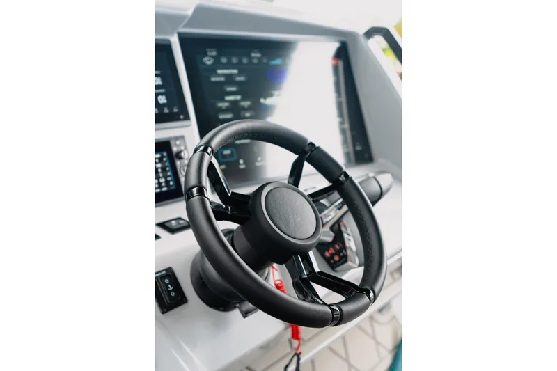  Yacht Photos Pics Steering wheel of 2026 Deep Impact 499 Sport boat with advanced dashboard controls.