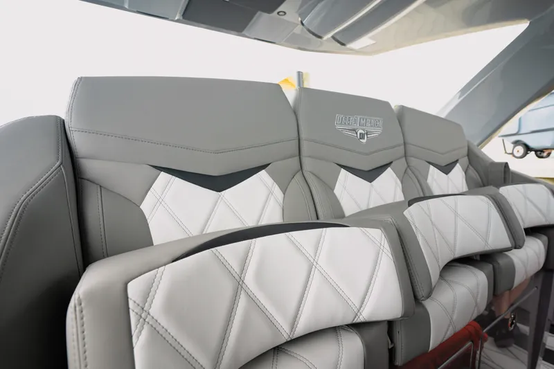 Yacht Photos Pics Luxurious seating in 2026 Deep Impact 499 Sport boat, featuring elegant gray and white upholstery.