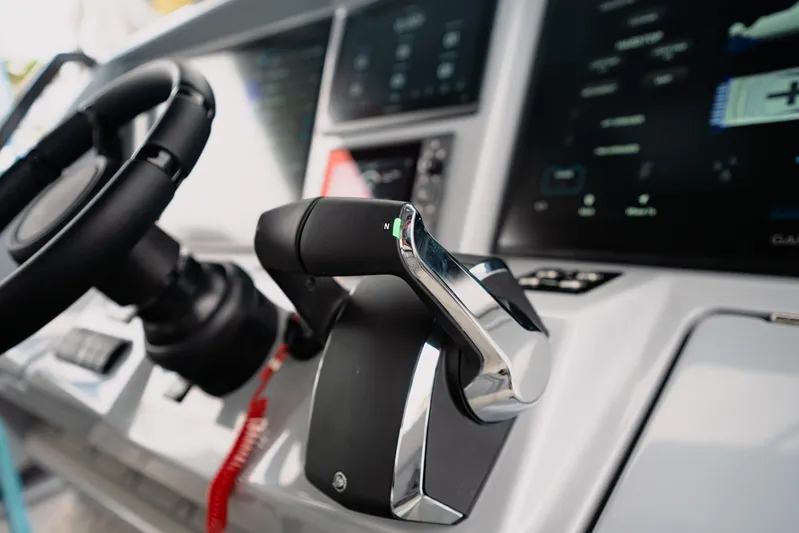  Yacht Photos Pics Close-up of 2026 Deep Impact 499 Sport boat controls and steering wheel.