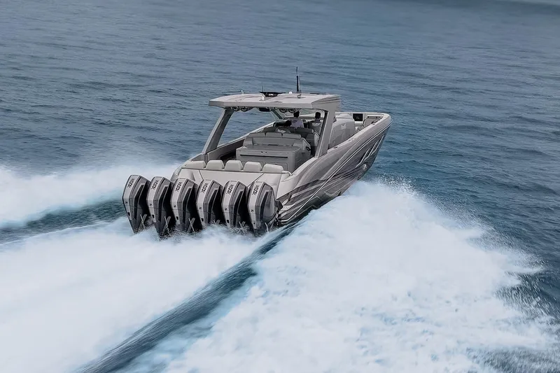  Yacht Photos Pics 2026 Deep Impact 499 Sport boat speeding on open water with powerful engines.