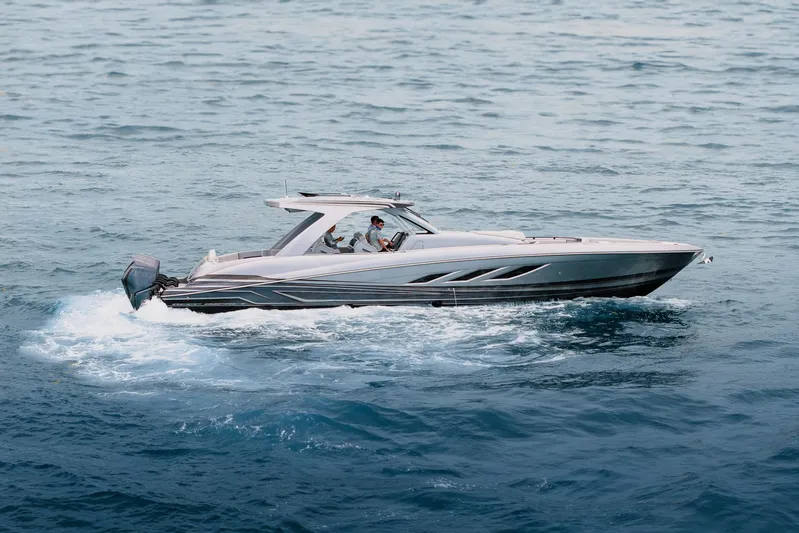  Yacht Photos Pics 2026 Deep Impact 499 Sport boat cruising on open water.