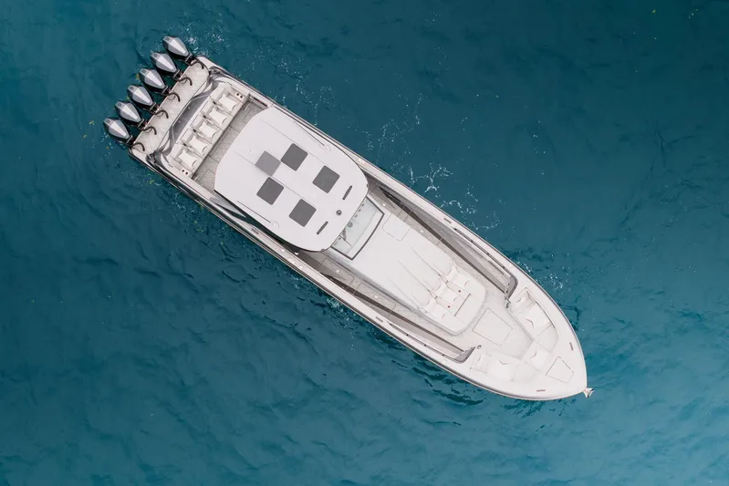  Yacht Photos Pics Aerial view of 2026 Deep Impact 499 Sport boat on blue water.