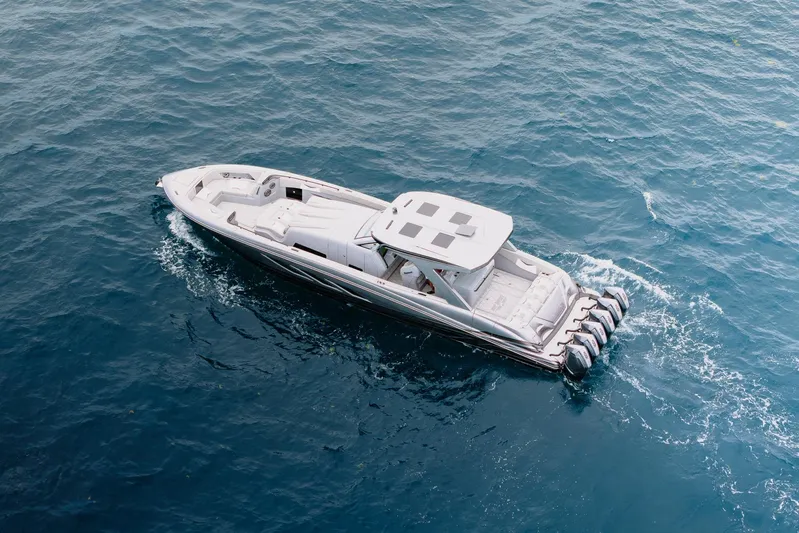  Yacht Photos Pics Aerial view of 2026 Deep Impact 499 Sport boat cruising on blue ocean waters.