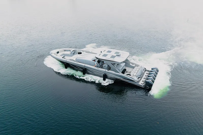  Yacht Photos Pics 2026 Deep Impact 499 Sport boat cruising on open water.