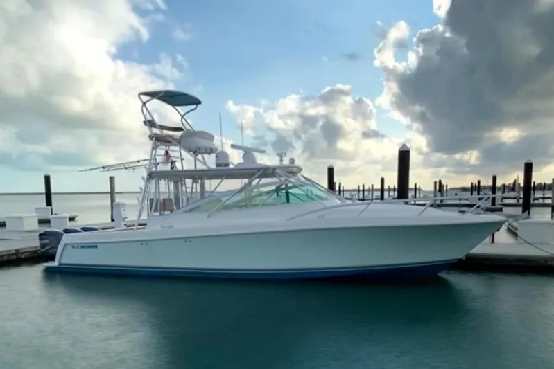 Maripal Yacht Photos Pics 2008 Contender 38 Express boat docked at marina under cloudy sky.