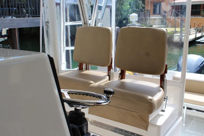 Maripal Yacht Photos Pics 2008 Contender 38 Express boat interior with dual beige captain seats and steering wheel.