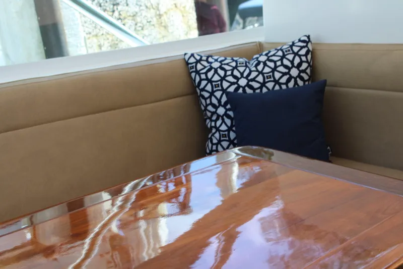 Maripal Yacht Photos Pics Interior of 2008 Contender 38 Express with polished wood table and decorative cushions.