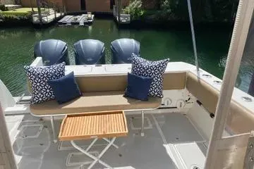 Maripal Yacht Photos Pics 2008 Contender 38 Express boat deck with seating, cushions, and table.