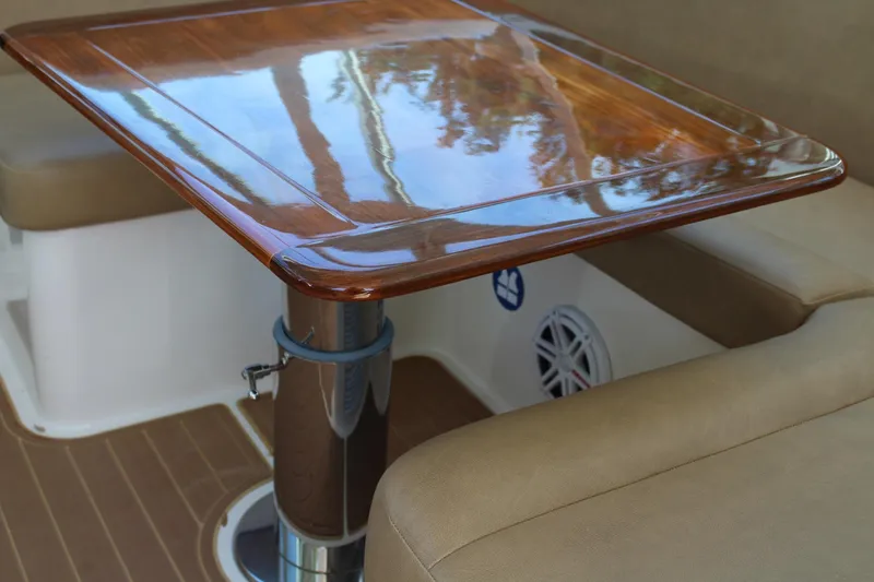 Maripal Yacht Photos Pics Luxurious wooden table on 2008 Contender 38 Express boat, surrounded by cushioned seating.