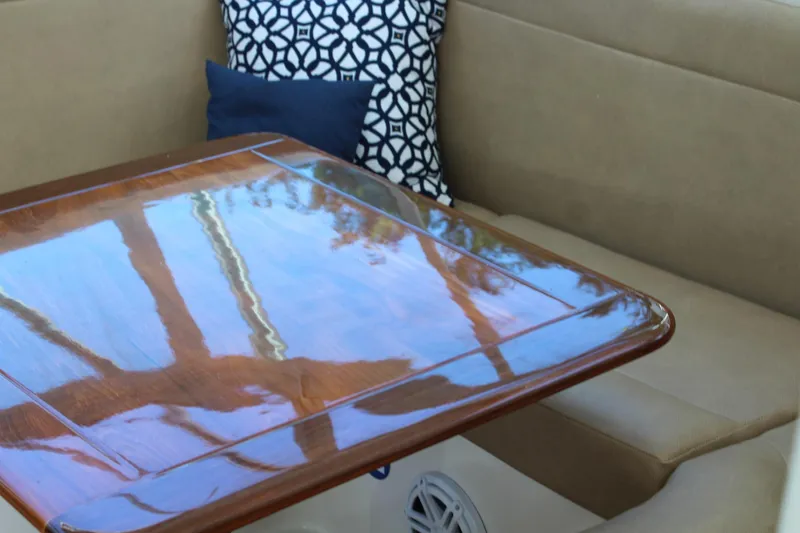 Maripal Yacht Photos Pics Interior of 2008 Contender 38 Express with polished wooden table and cushioned seating.