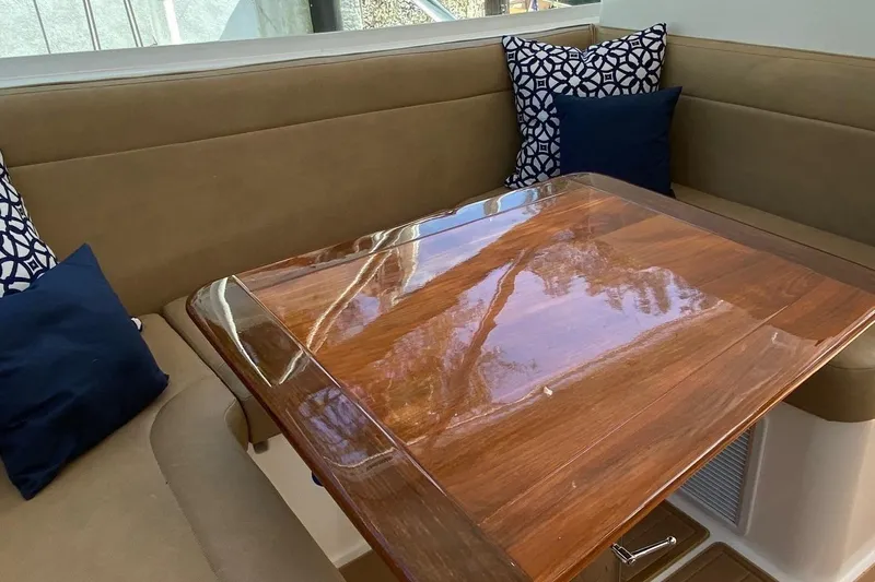 Maripal Yacht Photos Pics Luxurious interior of 2008 Contender 38 Express with polished wood table and cushioned seating.