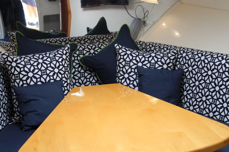 Maripal Yacht Photos Pics Interior of 2008 Contender 38 Express with patterned cushions and wooden table.