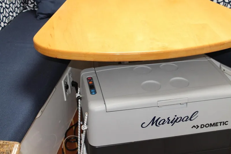 Maripal Yacht Photos Pics 2008 Contender 38 Express interior with wooden table and Dometic cooler.