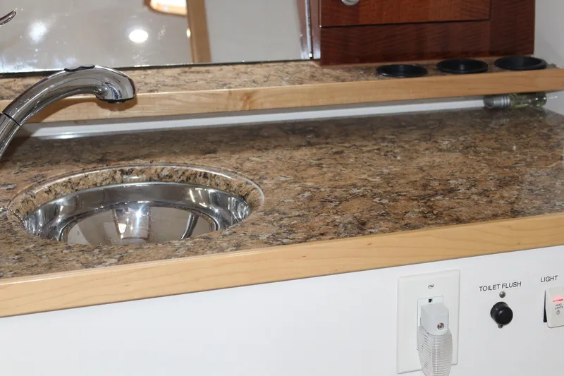 Maripal Yacht Photos Pics 2008 Contender 38 Express boat interior with granite countertop and stainless steel sink.