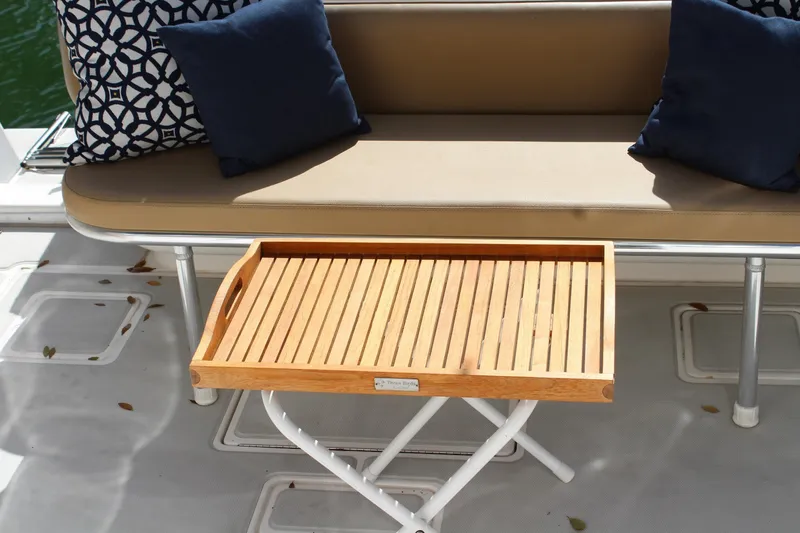 Maripal Yacht Photos Pics Luxury seating area on 2008 Contender 38 Express boat with wooden tray and cushions.