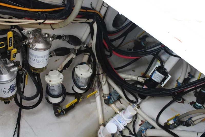 Maripal Yacht Photos Pics Engine compartment of a 2008 Contender 38 Express boat, showcasing wiring and fuel filters.